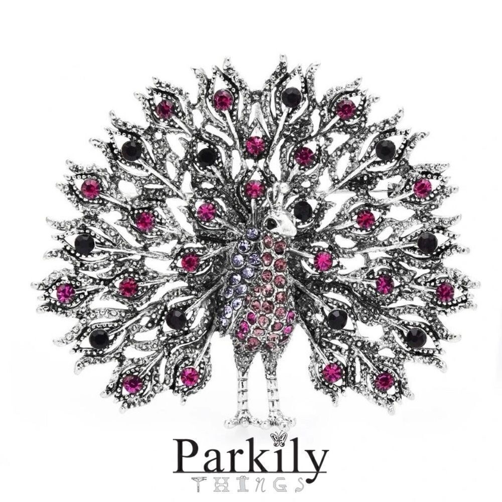 Brooch peacock in sparkly pink and black crystals in a silver pin setting